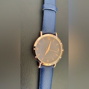 Dark blue watch with rose gold trim, little crystals around. Never worn.